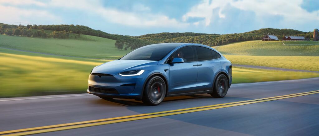 Tesla Model X driving on a scenic mountain road – Tesla Model X referral link rewards in 2025