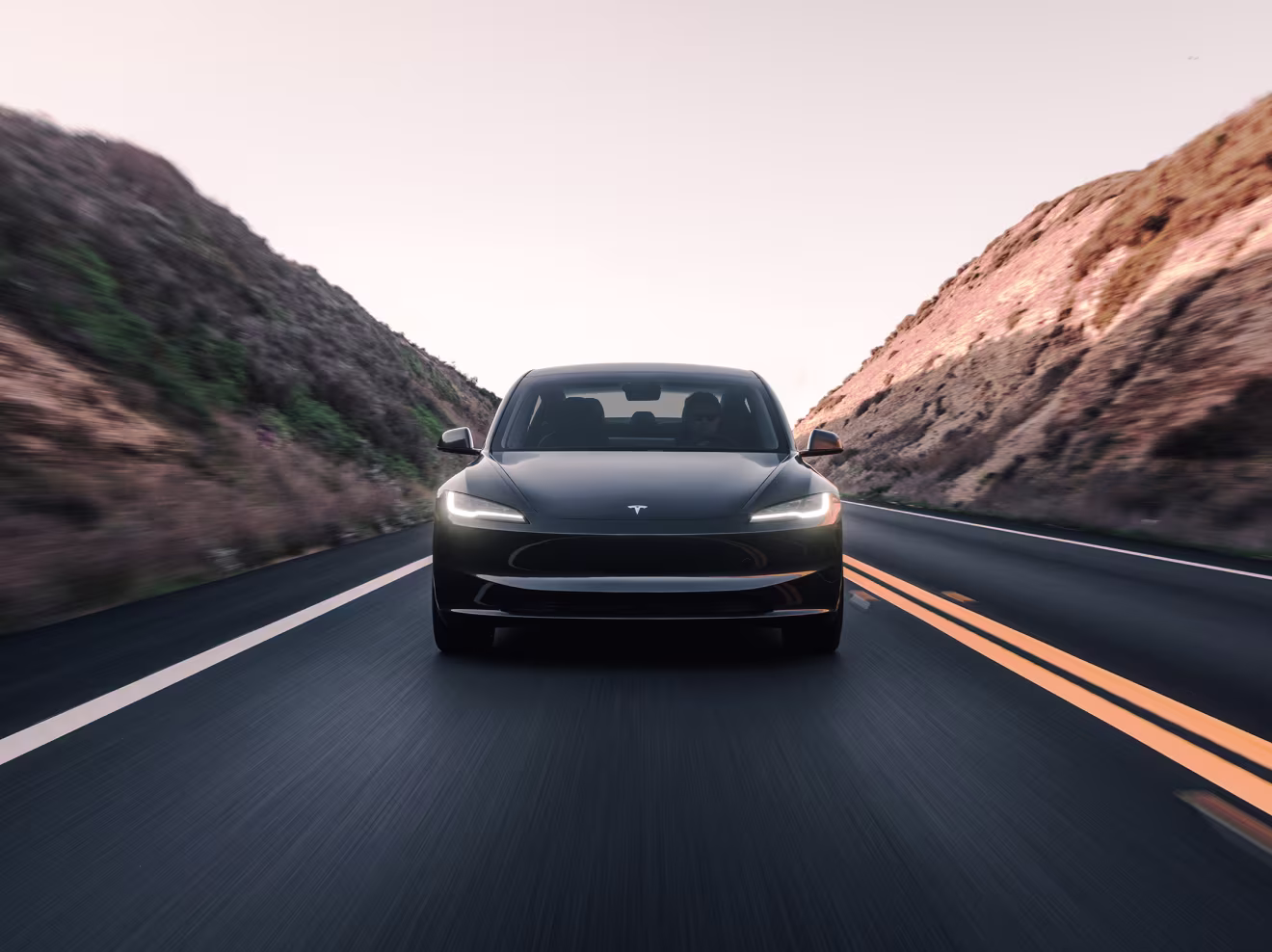 Side view of Tesla Model 3 with referral link banner