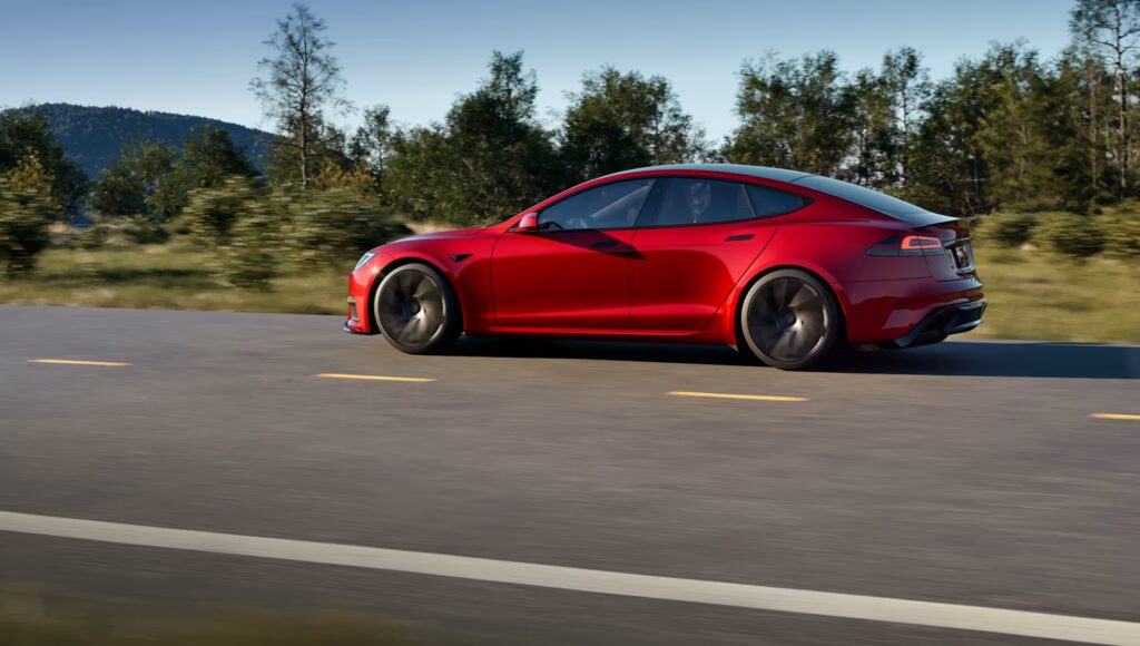 Tesla owner using phone to access referral code benefits for new car.